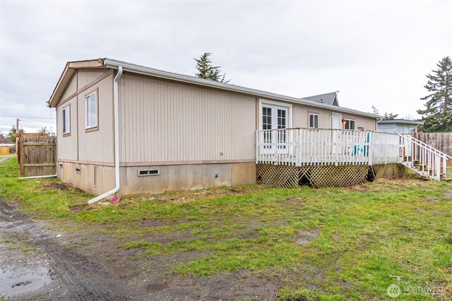 exterior space featuring a deck, a yard, and fence