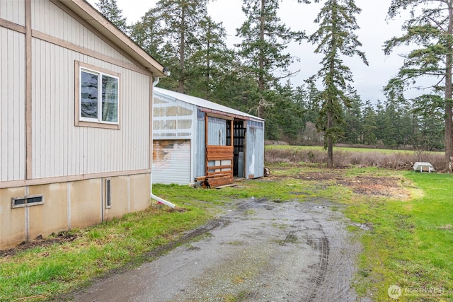 exterior space featuring dirt driveway