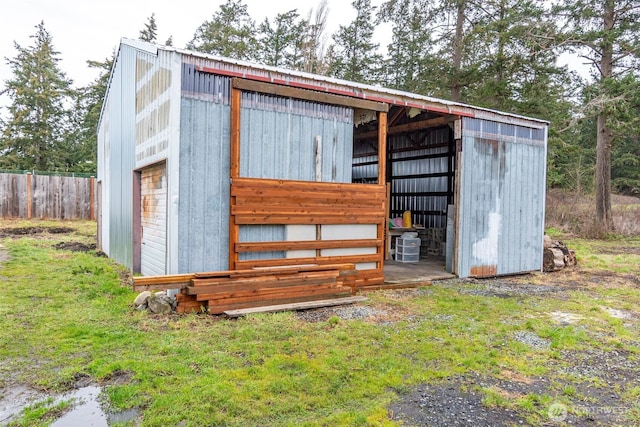 view of pole building featuring fence