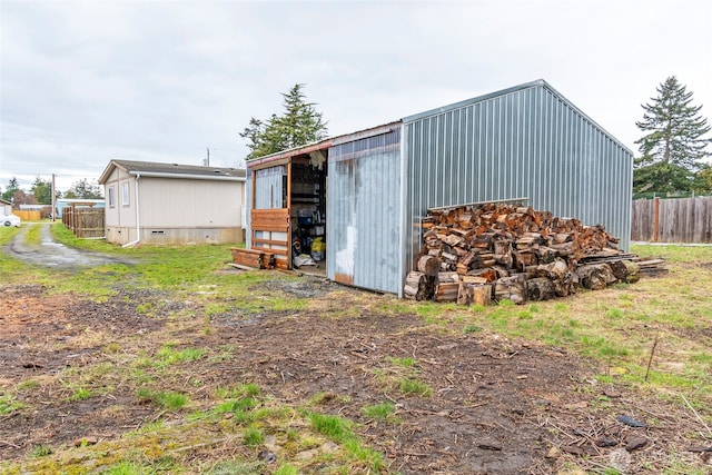 view of pole building featuring fence