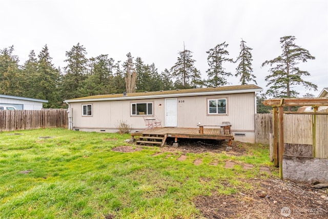 back of property with a deck, crawl space, and a fenced backyard