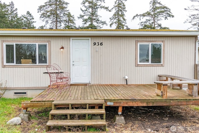 view of exterior entry with a deck