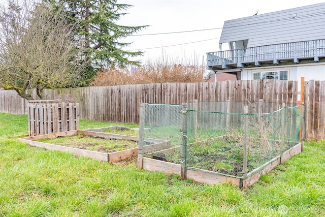 view of yard featuring fence and a garden