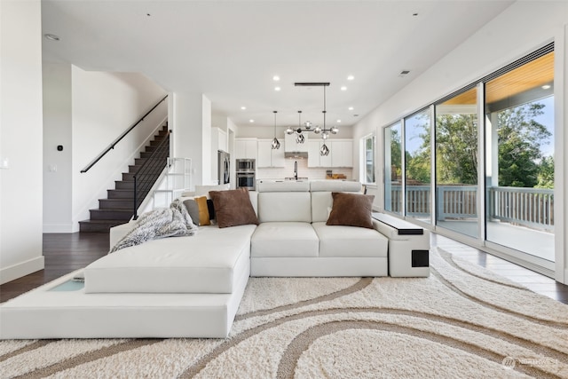 living room featuring sink and light hardwood / wood-style flooring