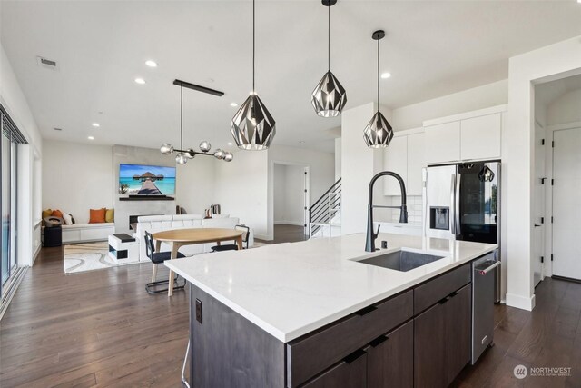 kitchen with dark hardwood / wood-style flooring, white cabinetry, stainless steel appliances, and dark brown cabinetry