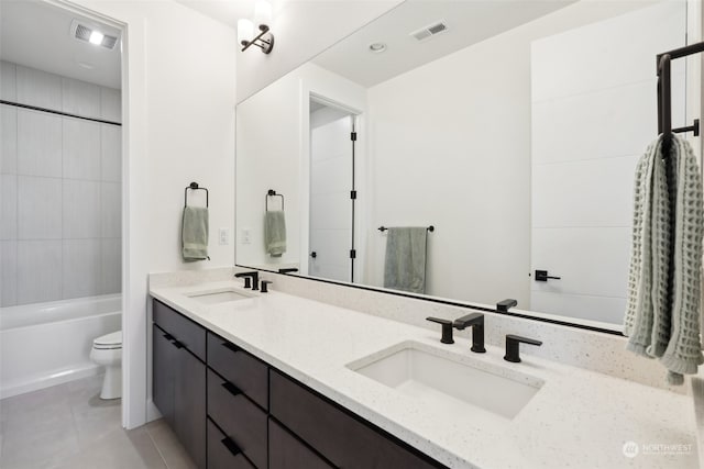 full bathroom featuring tiled shower / bath combo, toilet, tile patterned floors, and dual bowl vanity