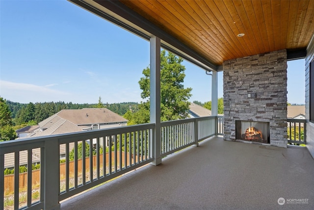 balcony with an outdoor stone fireplace