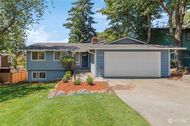 view of front of home with a garage and a front lawn