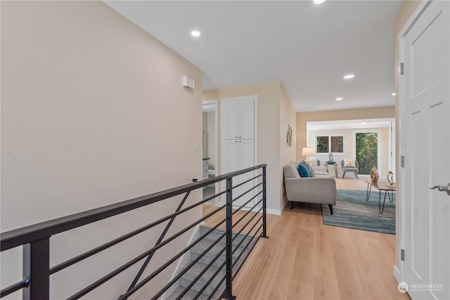 corridor with light hardwood / wood-style floors