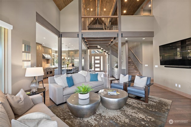 living room featuring a towering ceiling, wood-type flooring, and wooden ceiling