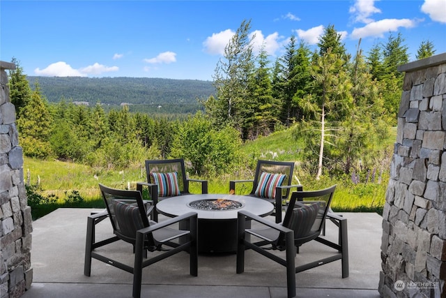 view of patio / terrace featuring an outdoor fire pit