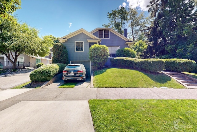 view of front of home featuring a garage and a front lawn