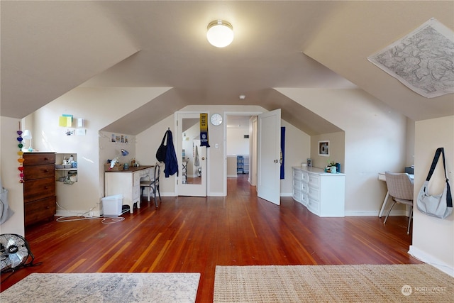 bonus room with lofted ceiling, baseboards, and wood finished floors