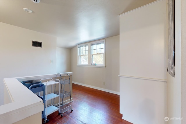 office area featuring baseboards, visible vents, vaulted ceiling, and dark wood-style flooring