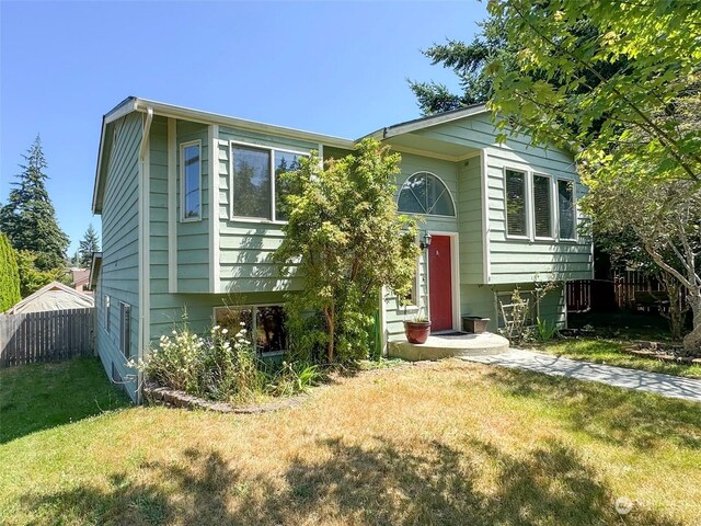 split foyer home with a front lawn