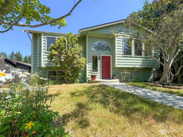 split foyer home featuring a front lawn