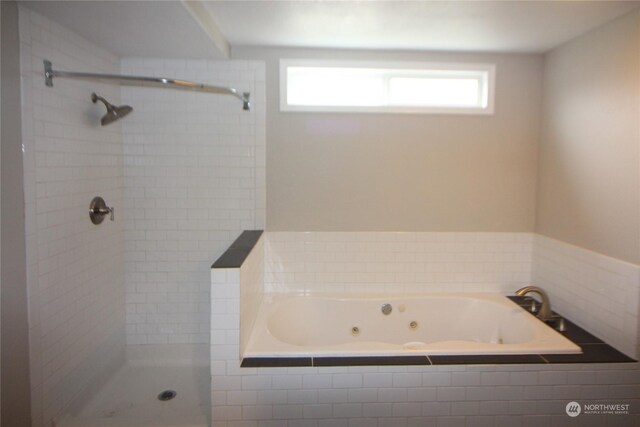 bathroom featuring independent shower and bath and a wealth of natural light