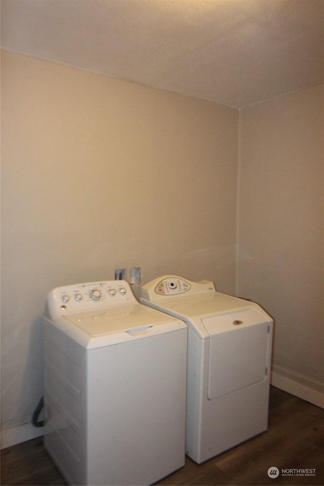 laundry area with washing machine and clothes dryer and hardwood / wood-style floors