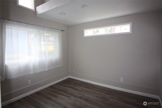 unfurnished room featuring dark hardwood / wood-style flooring