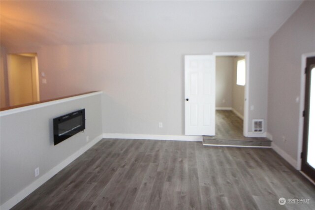 unfurnished living room with wood-type flooring