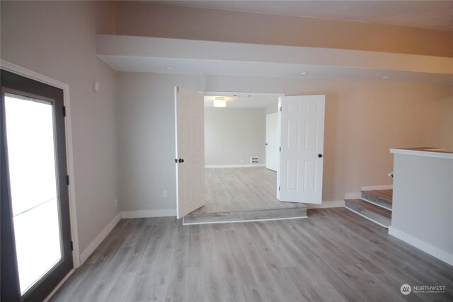 spare room with a healthy amount of sunlight and light wood-type flooring