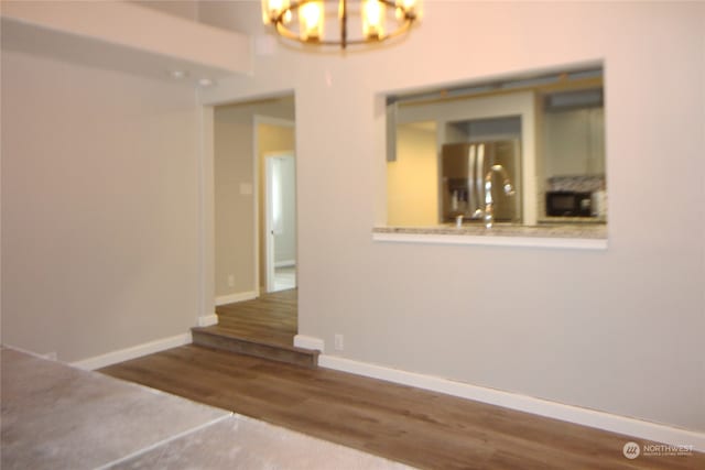 interior space featuring hardwood / wood-style flooring and a notable chandelier