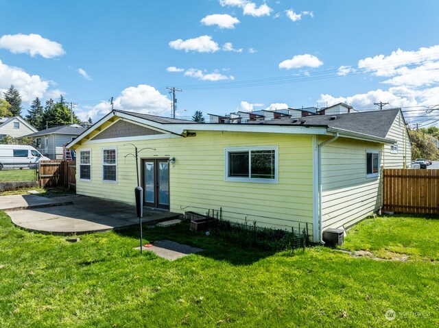 back of house featuring a yard and a patio