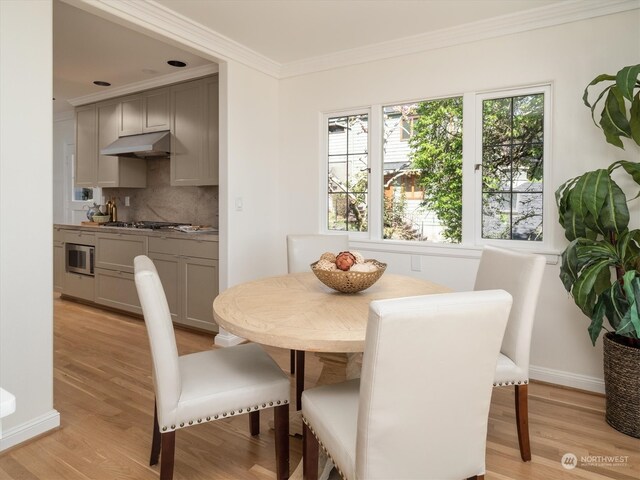 dining room featuring crown molding and light wood-type flooring