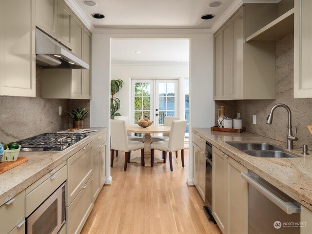 kitchen featuring ornamental molding, sink, tasteful backsplash, and light wood-type flooring