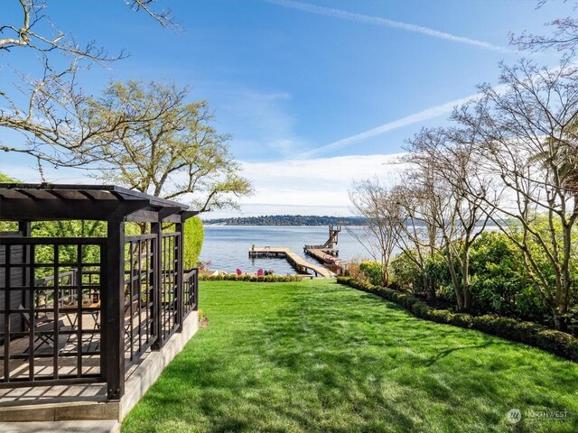 view of yard with a boat dock and a water view