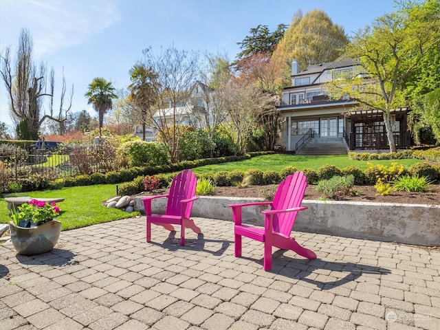 view of patio / terrace featuring a sunroom and an outdoor fire pit