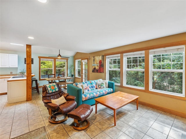 tiled living room with vaulted ceiling and sink