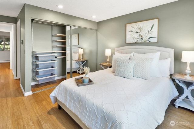 bedroom featuring hardwood / wood-style flooring and a closet