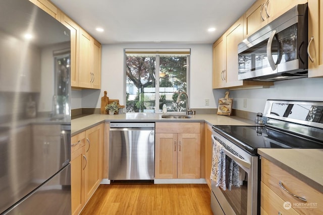 kitchen featuring sink, stainless steel appliances, and light brown cabinets