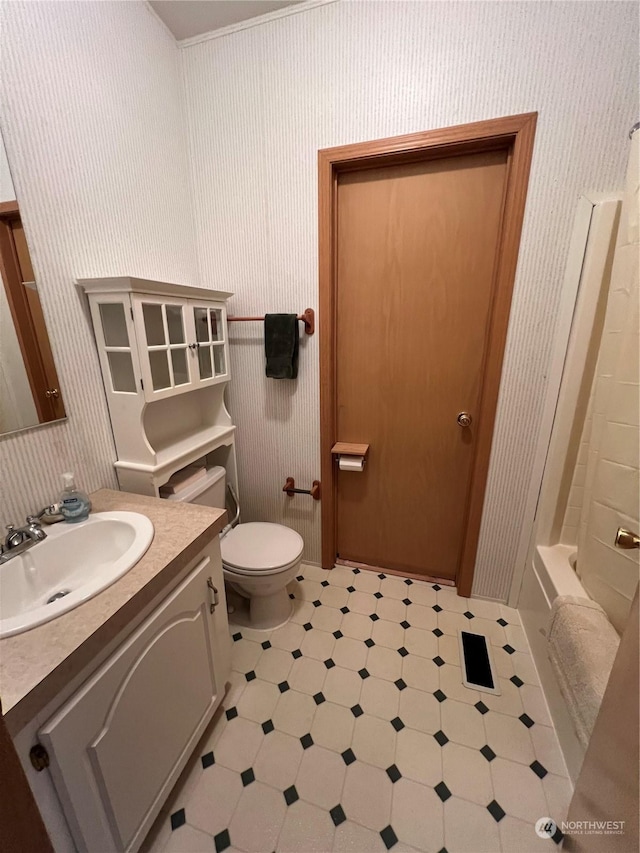 bathroom with vanity, toilet, and tile patterned flooring