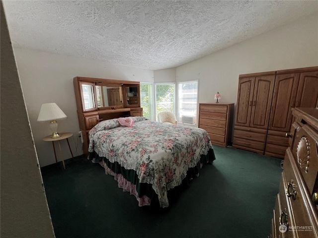 bedroom with dark carpet and a textured ceiling