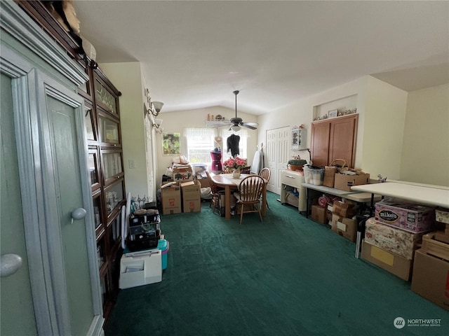 carpeted dining space with ceiling fan and lofted ceiling