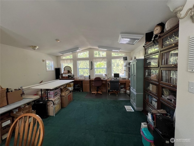 carpeted home office featuring lofted ceiling