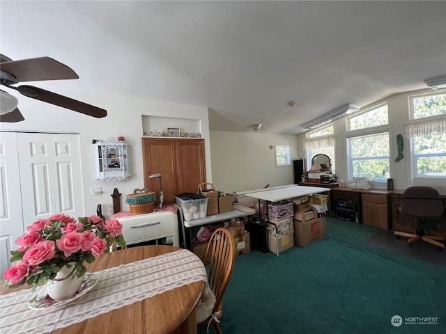 carpeted dining area with lofted ceiling