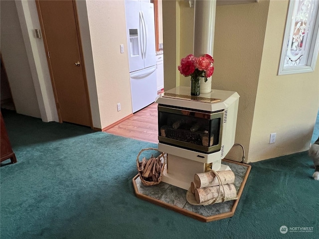 interior details featuring white refrigerator with ice dispenser and carpet