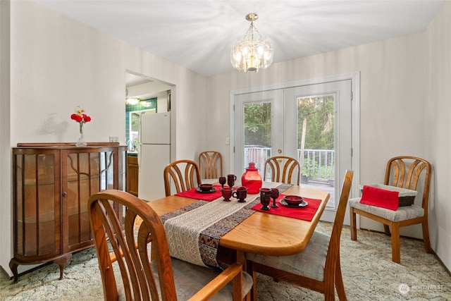 dining room featuring french doors and a chandelier