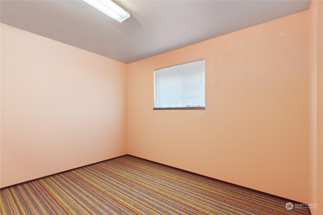 unfurnished room featuring carpet flooring