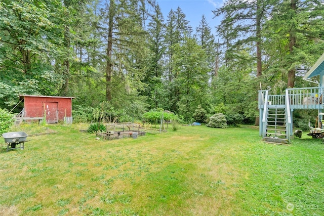 view of yard with a wooden deck and a shed