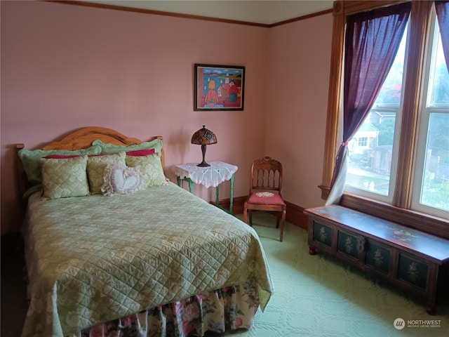 carpeted bedroom featuring crown molding