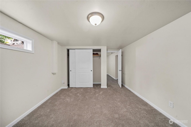 unfurnished bedroom with a closet and carpet flooring