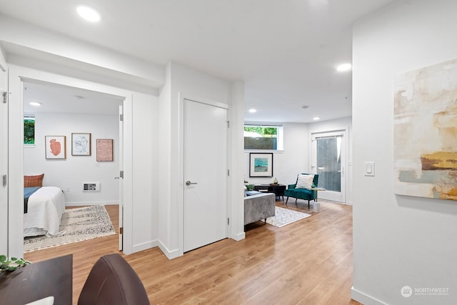 hallway with light hardwood / wood-style flooring