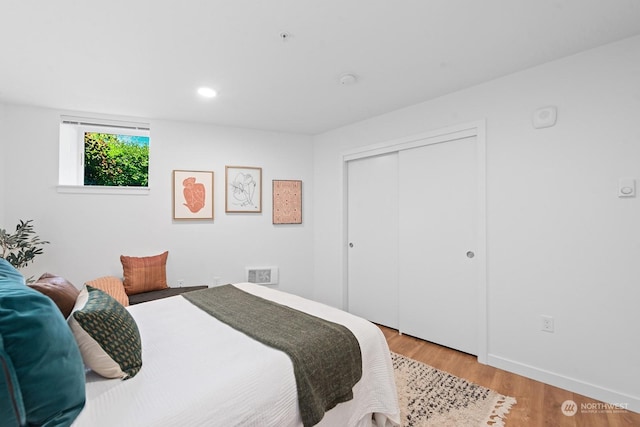 bedroom featuring light hardwood / wood-style floors and a closet