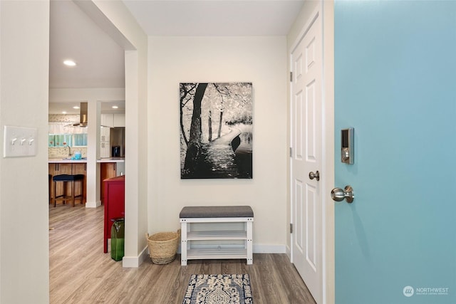 hallway with hardwood / wood-style floors