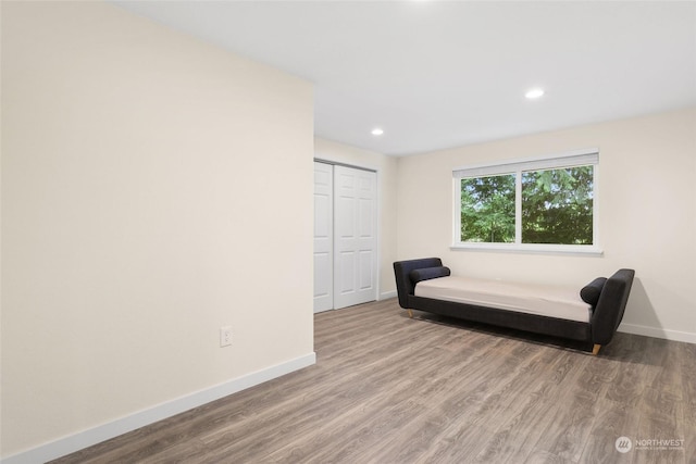 bedroom with wood-type flooring and a closet