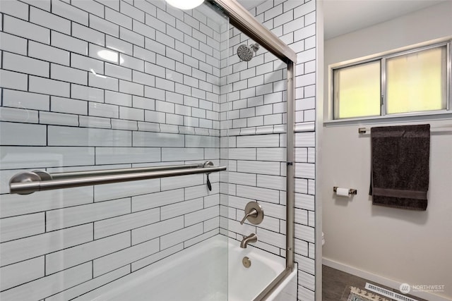 bathroom with enclosed tub / shower combo